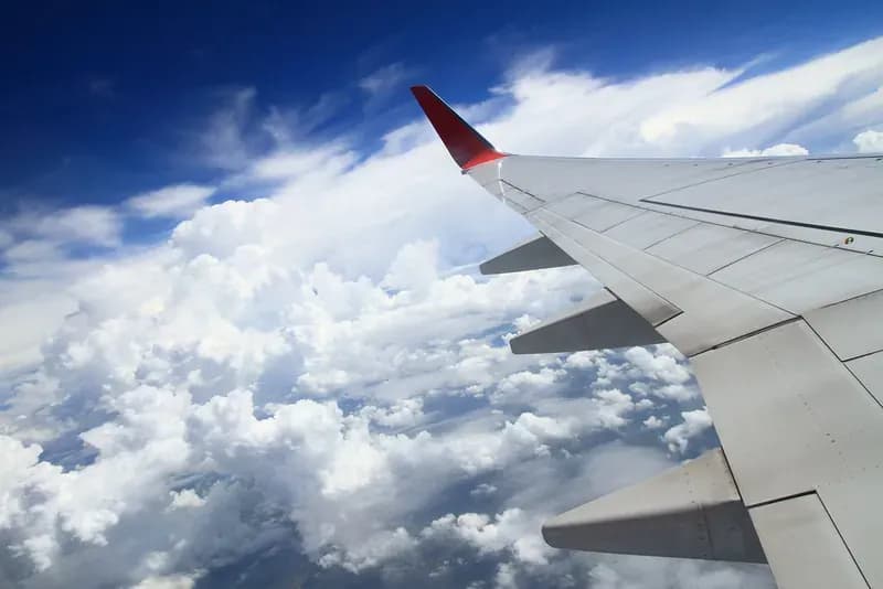 An airplane wing above the clouds